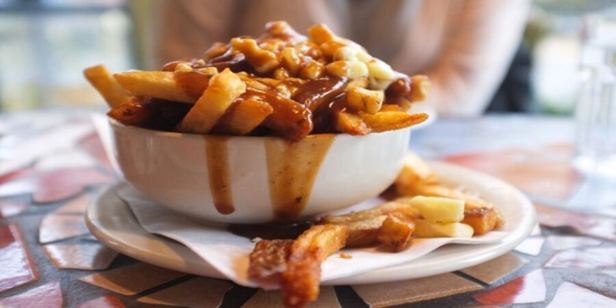 Montreal: Best of Montreal Food Walking Tour with Tastings - Poutine stop: fries, gravy, and cheese curds on the move